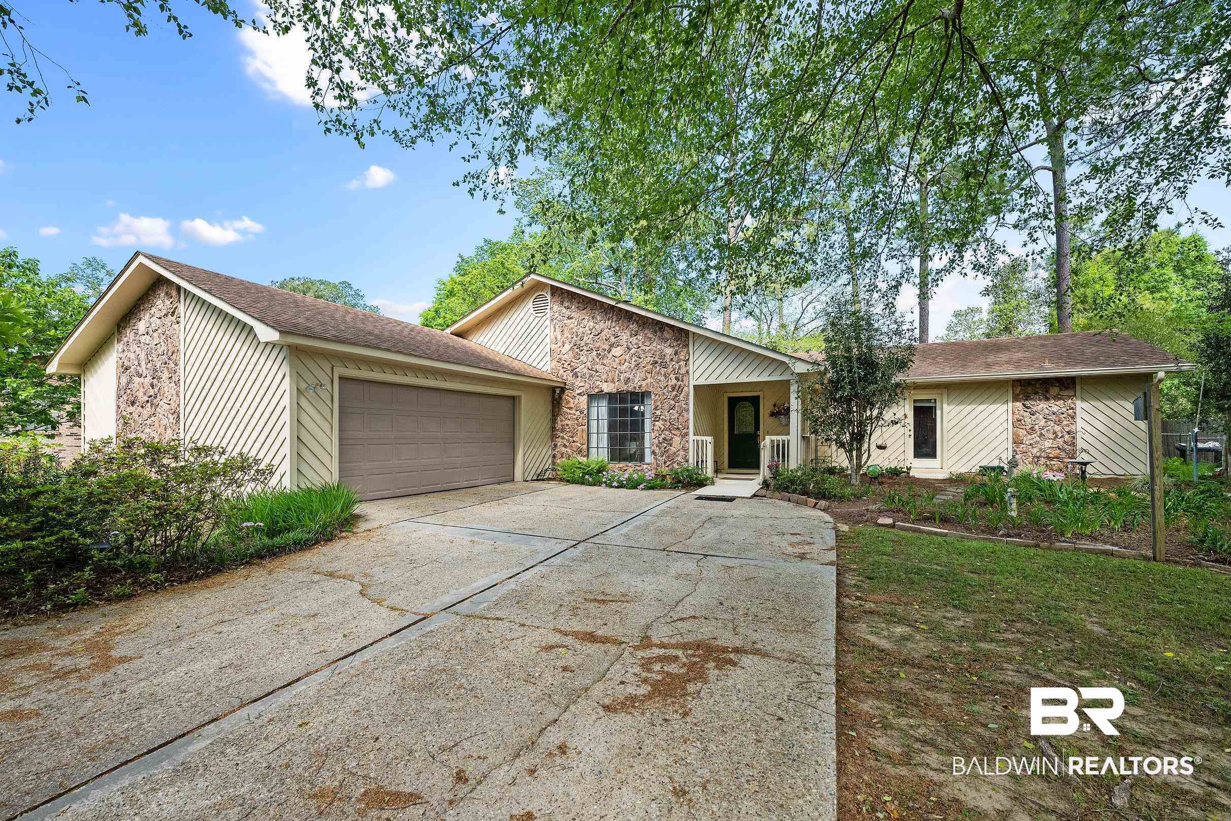 4026 Kingsrow Row Mobile, AL 36619 - Photo 1 of 51 View of front of house featuring an attached garage, stone siding, and driveway