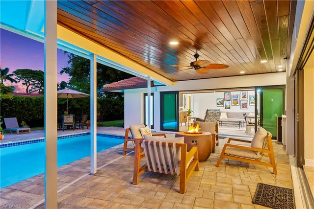 a view of swimming pool with seating area