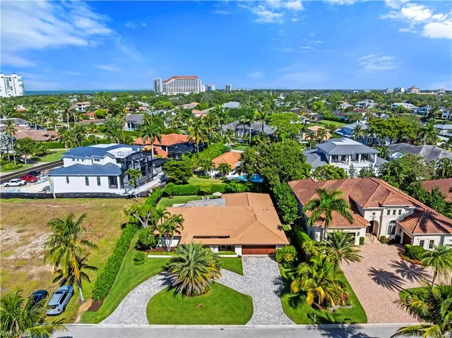 an aerial view of residential houses with outdoor space and swimming pool