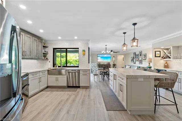 a kitchen with kitchen island granite countertop lots of counter top space and stainless steel appliances