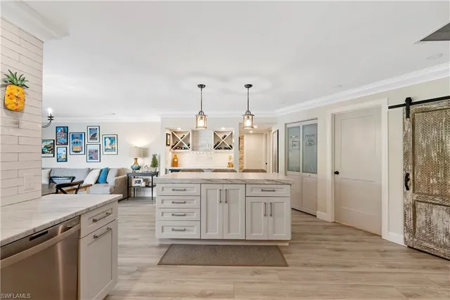 a large kitchen with kitchen island a sink stainless steel appliances and cabinets