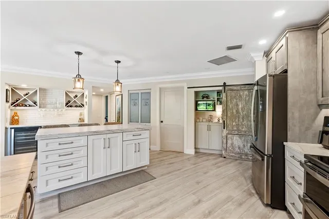 a kitchen with granite countertop a refrigerator and a sink