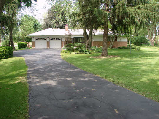 6911 Halley Road Rockford, IL 61101 - Photo 1 of 11 a front view of a house with garden