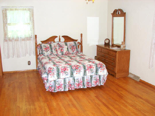 6911 Halley Road Rockford, IL 61101 - Photo 11 of 11 a bedroom with a bed and a dresser next to a window