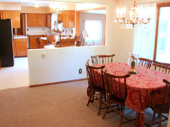 6911 Halley Road Rockford, IL 61101 - Photo 9 of 11 a dining room with furniture and a chandelier