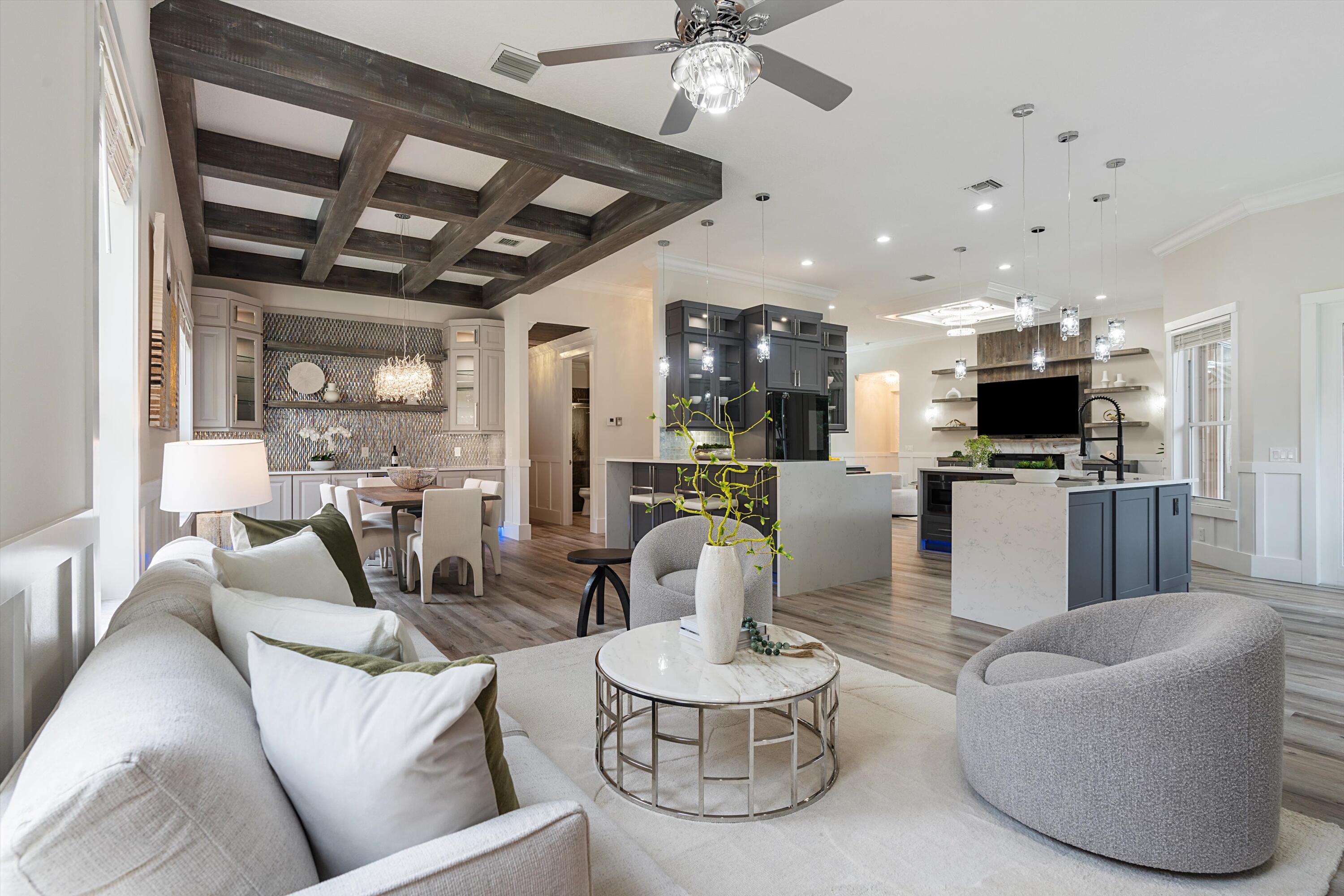 a living room with furniture and a view of kitchen