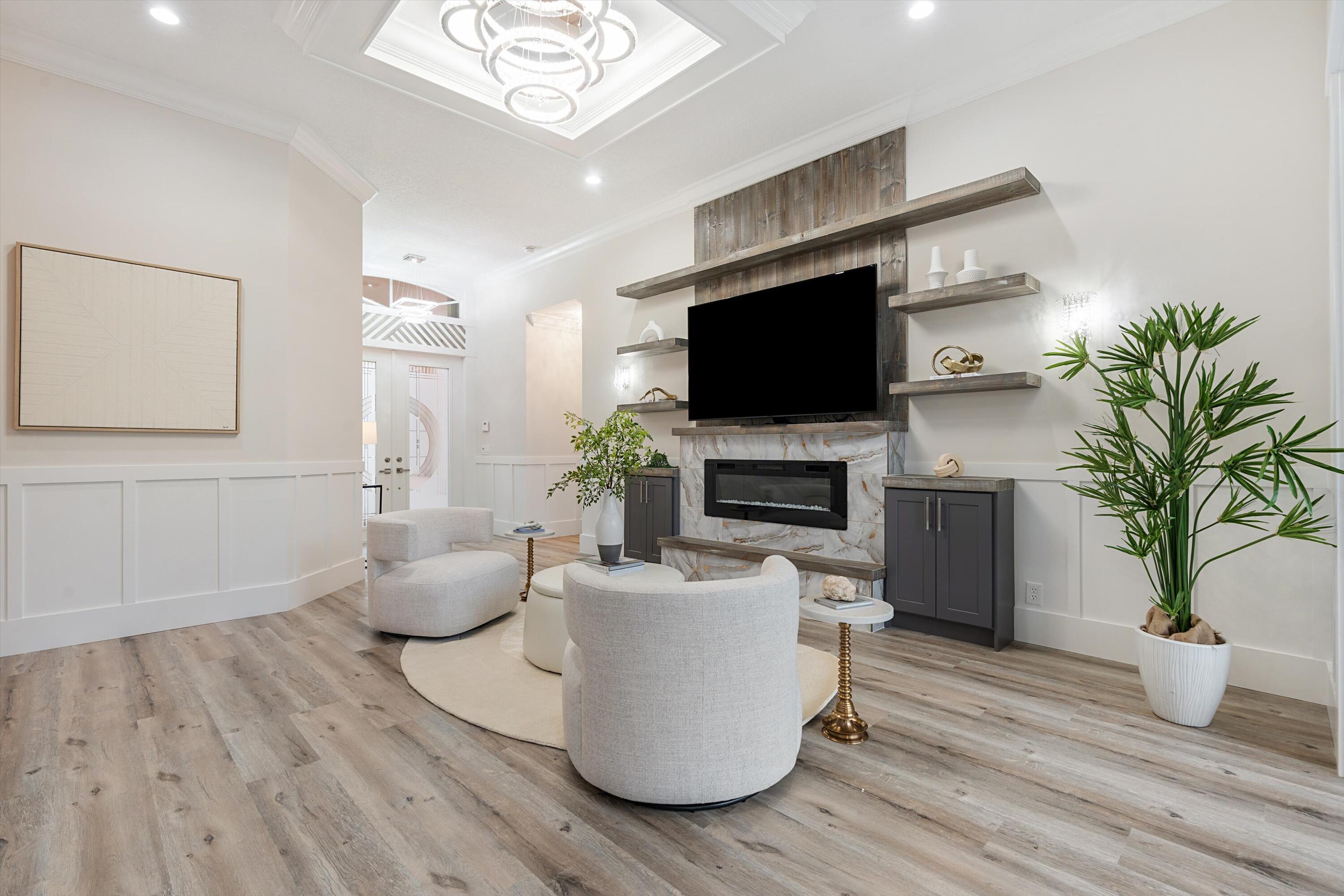 6661 Garde Road Boynton Beach, FL 33472 - Photo 11 of 48 a living room with furniture a flat screen tv and a potted plant