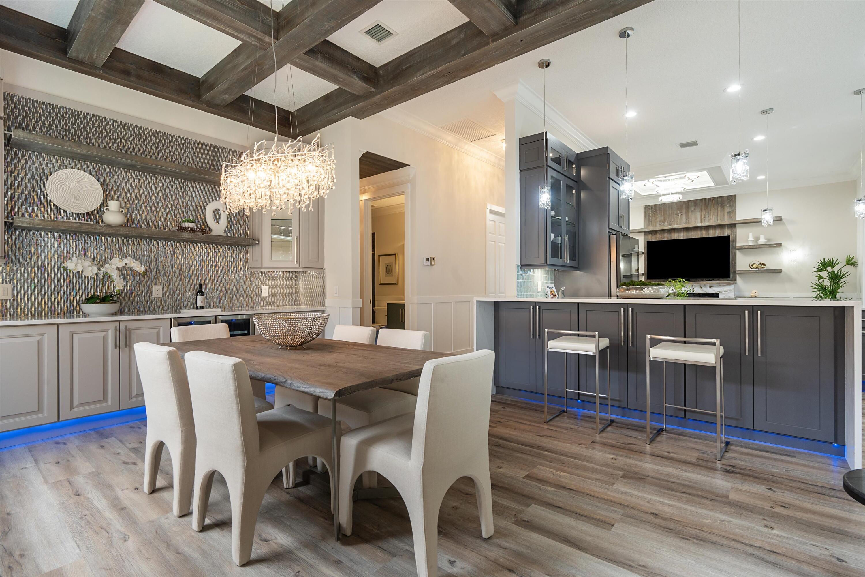 6661 Garde Road Boynton Beach, FL 33472 - Photo 14 of 48 a view of a dining room with furniture and wooden floor