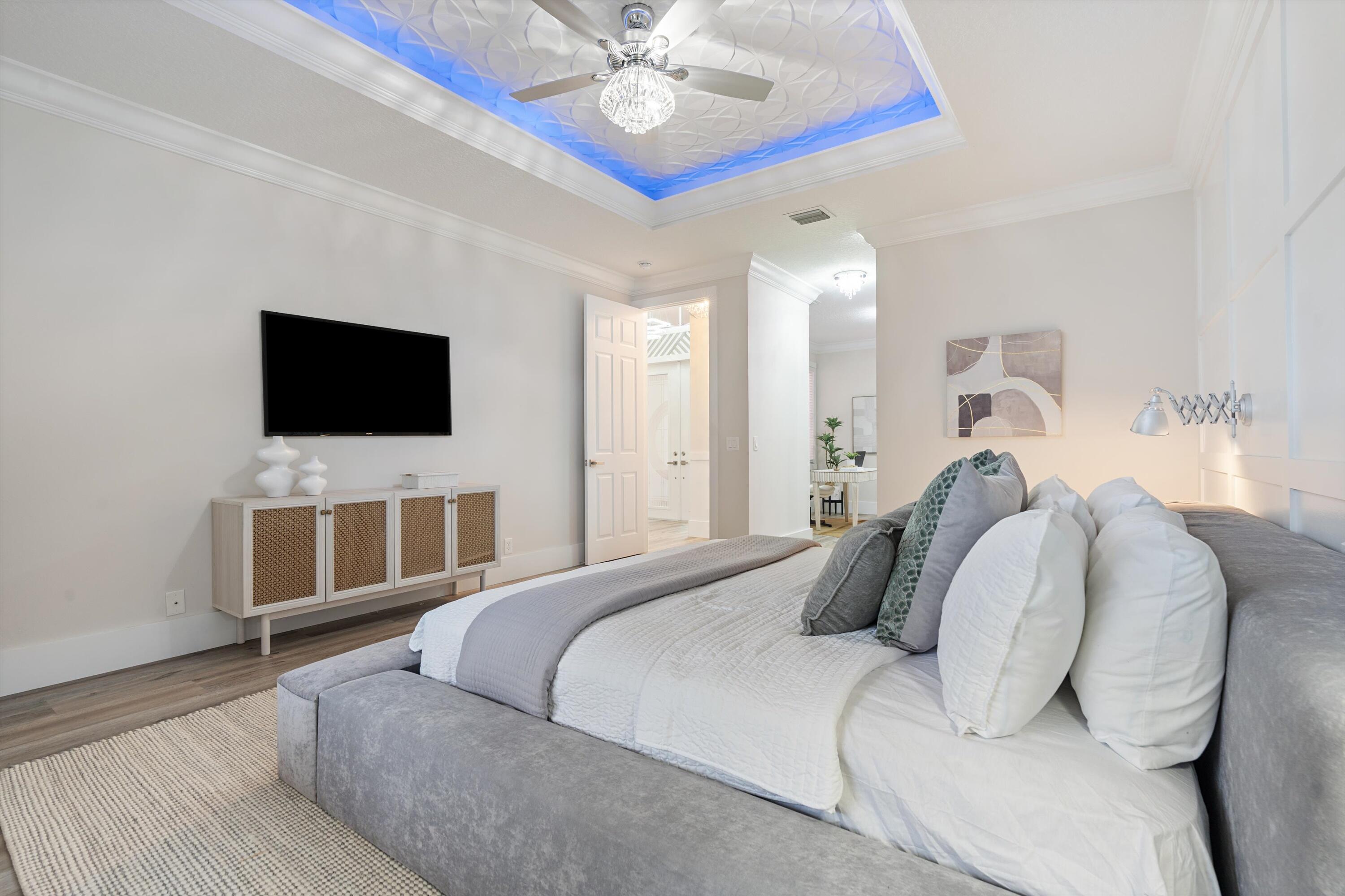 6661 Garde Road Boynton Beach, FL 33472 - Photo 15 of 48 a bedroom with a large bed and a flat screen tv