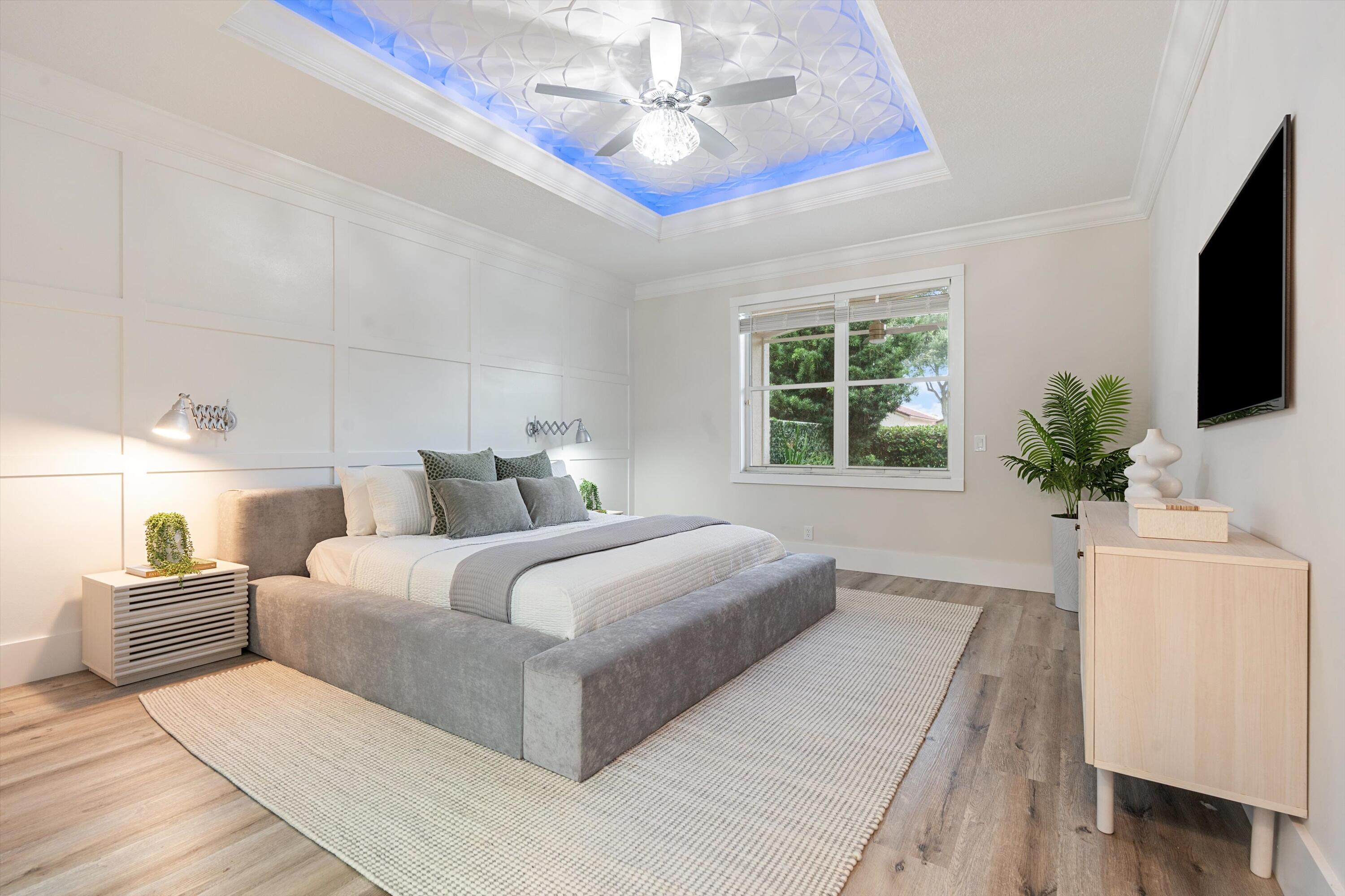 6661 Garde Road Boynton Beach, FL 33472 - Photo 16 of 48 a bedroom with a large bed and a flat screen tv