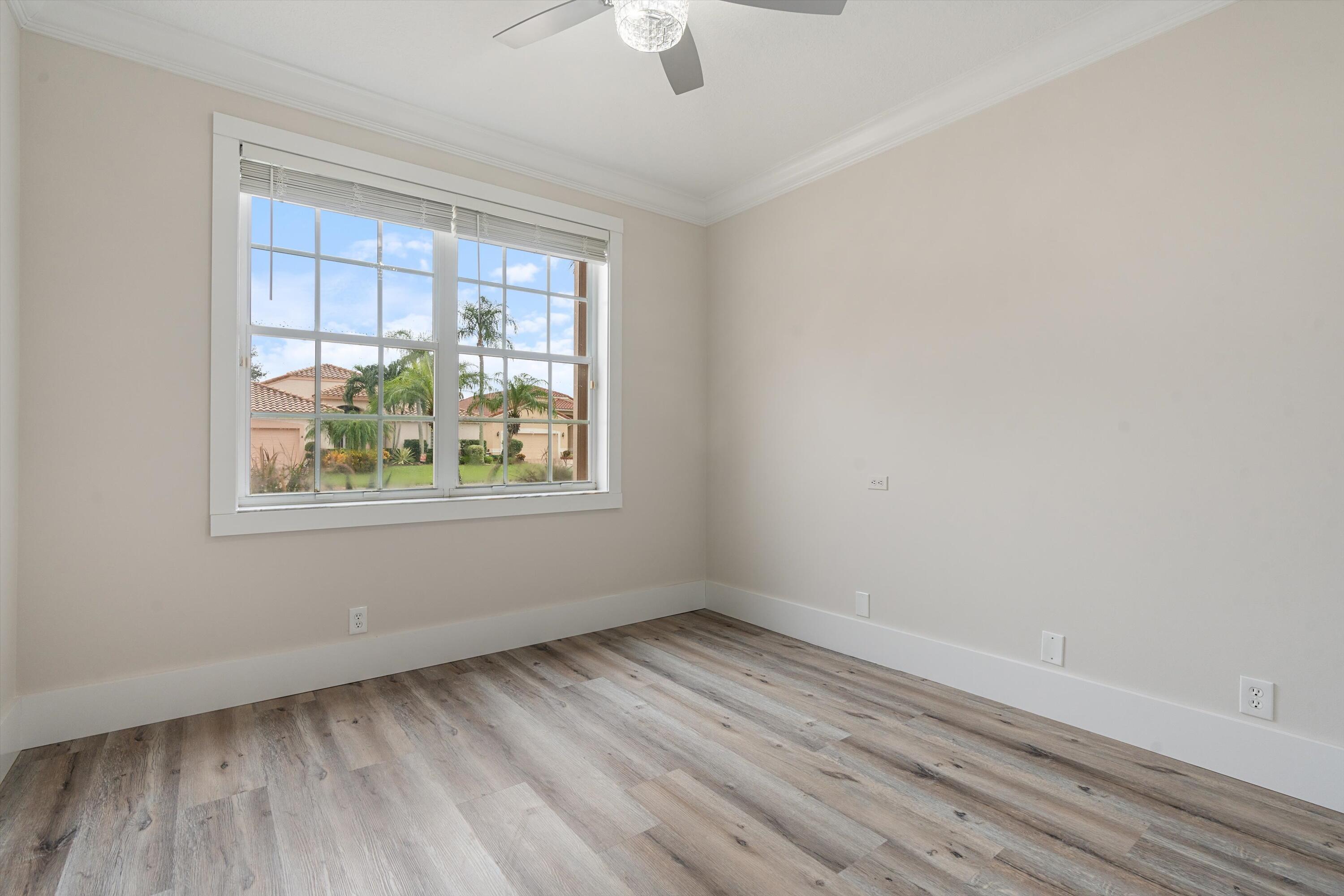 6661 Garde Road Boynton Beach, FL 33472 - Photo 21 of 48 wooden floor in an empty room with a window