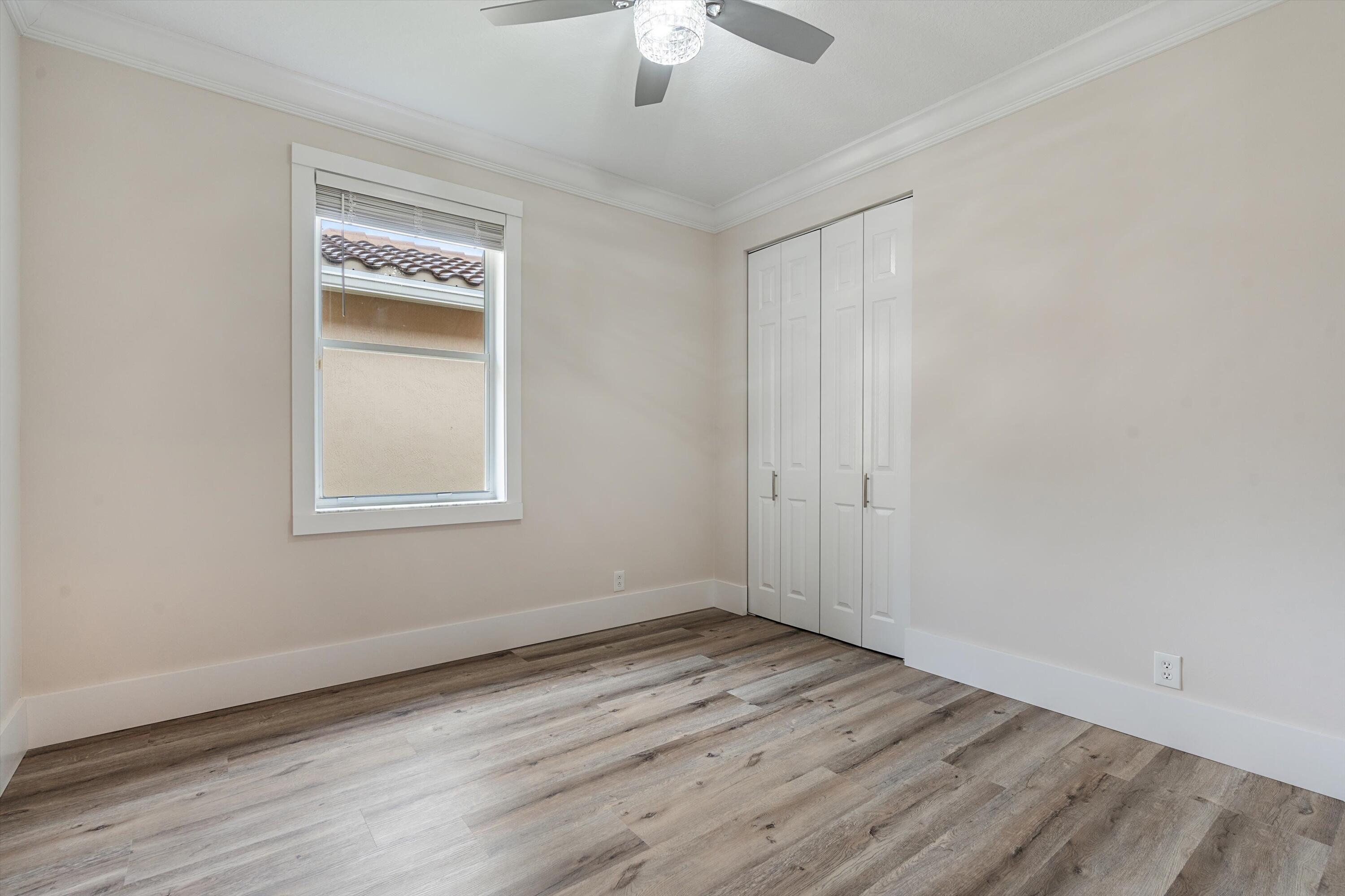 6661 Garde Road Boynton Beach, FL 33472 - Photo 24 of 48 wooden floor in an empty room with a window