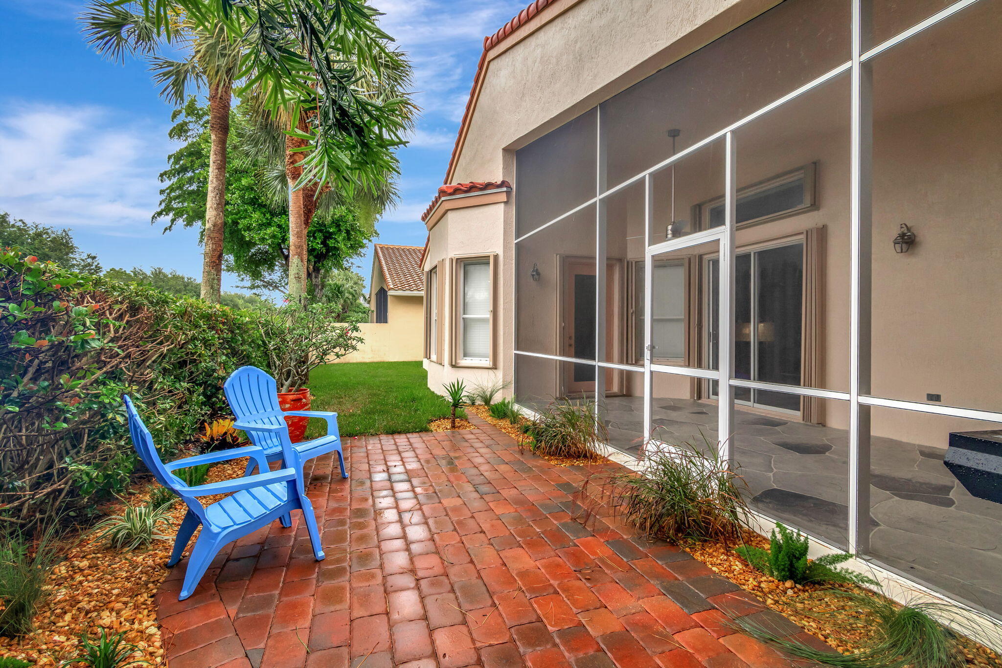 6661 Garde Road Boynton Beach, FL 33472 - Photo 31 of 48 a view of a chair and table in backyard