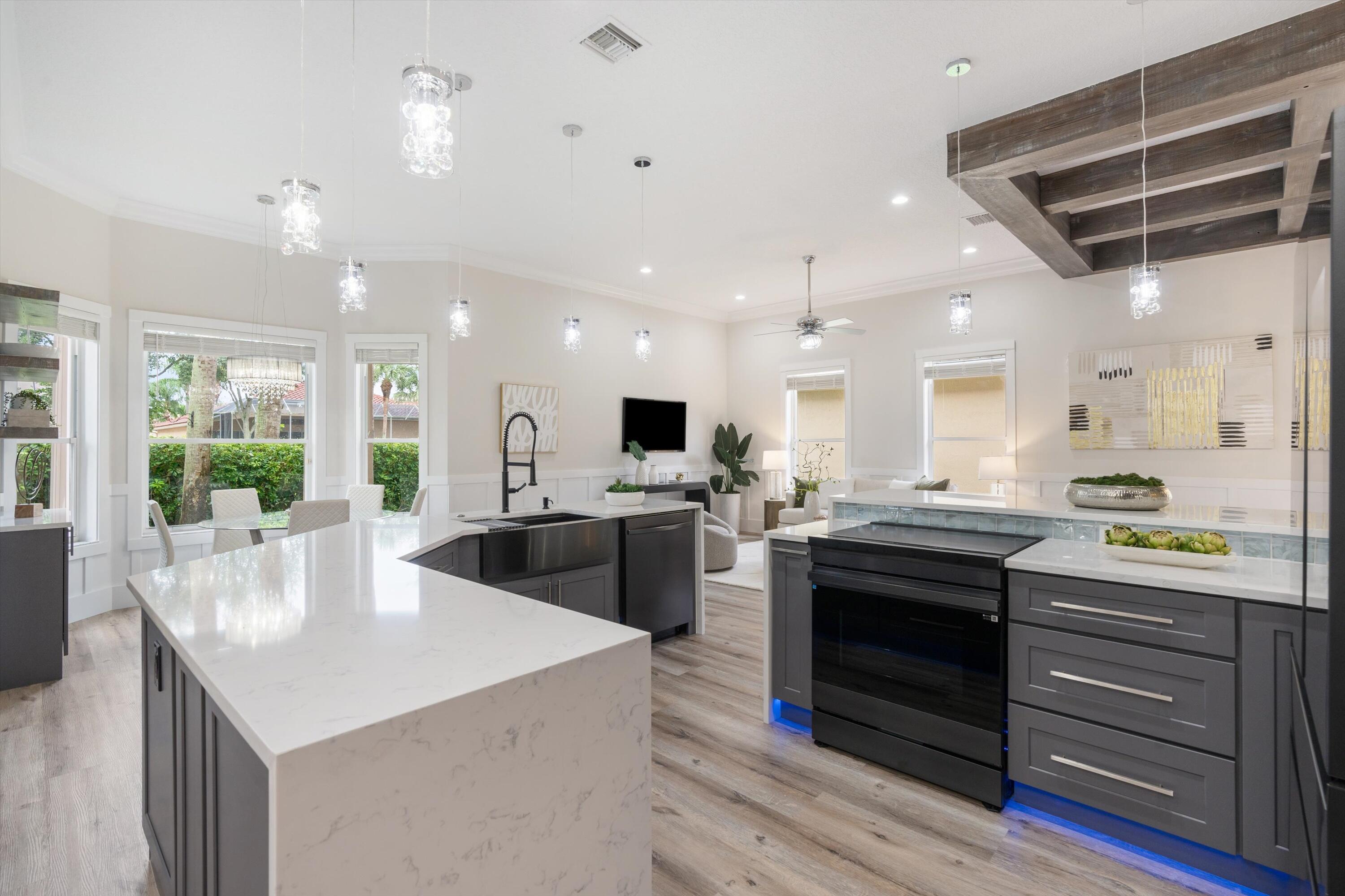 6661 Garde Road Boynton Beach, FL 33472 - Photo 8 of 48 a kitchen with stainless steel appliances granite countertop a stove and a refrigerator