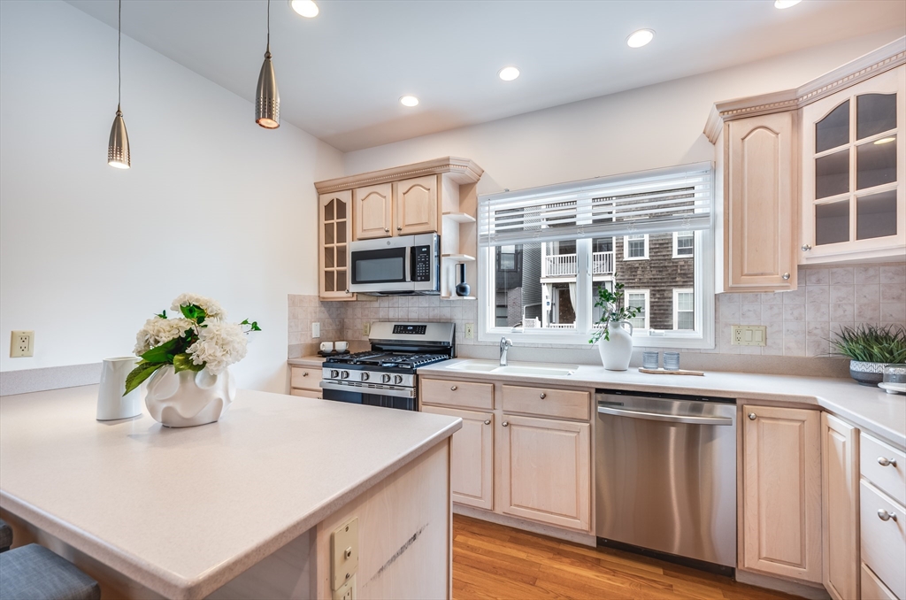 1520 Columbia Road, Unit 2 Boston, MA 02127 - Photo 8 of 16 a kitchen with a sink dishwasher stove and microwave