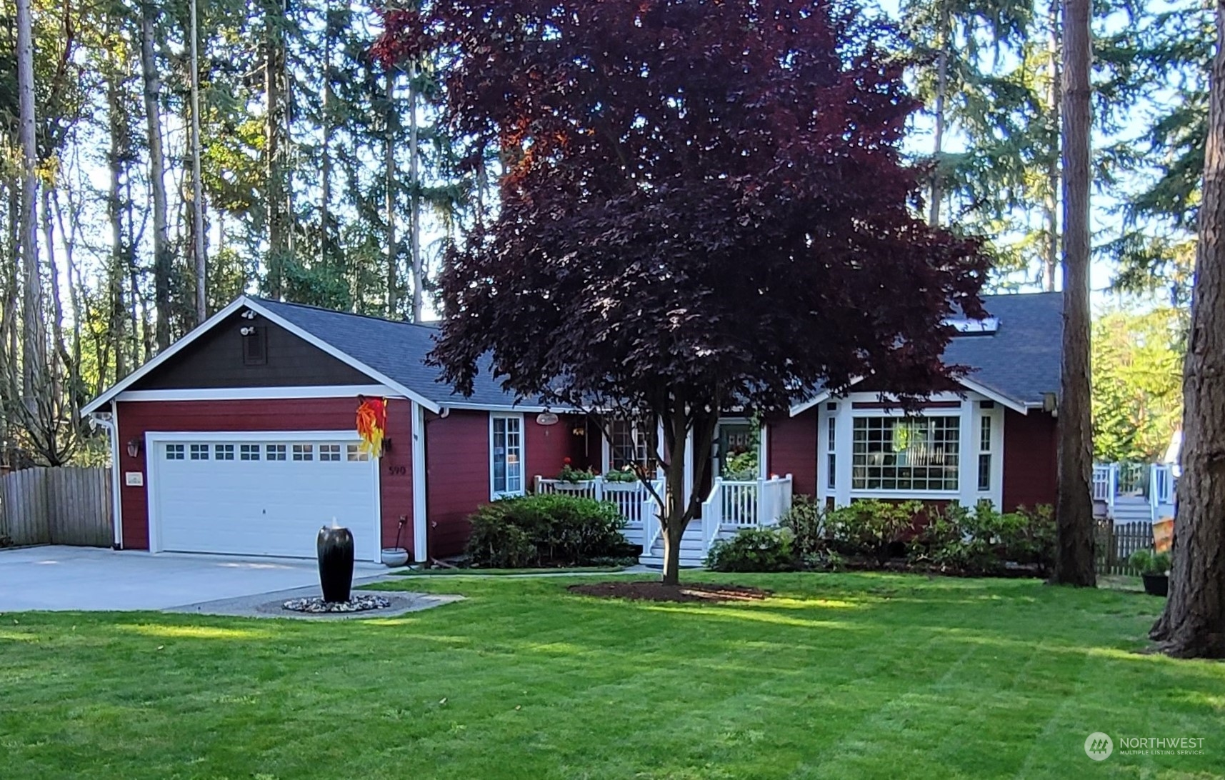 590 East Bush Point Road Freeland, WA 98249 - Photo 1 of 25 a front view of a house with a yard and trees