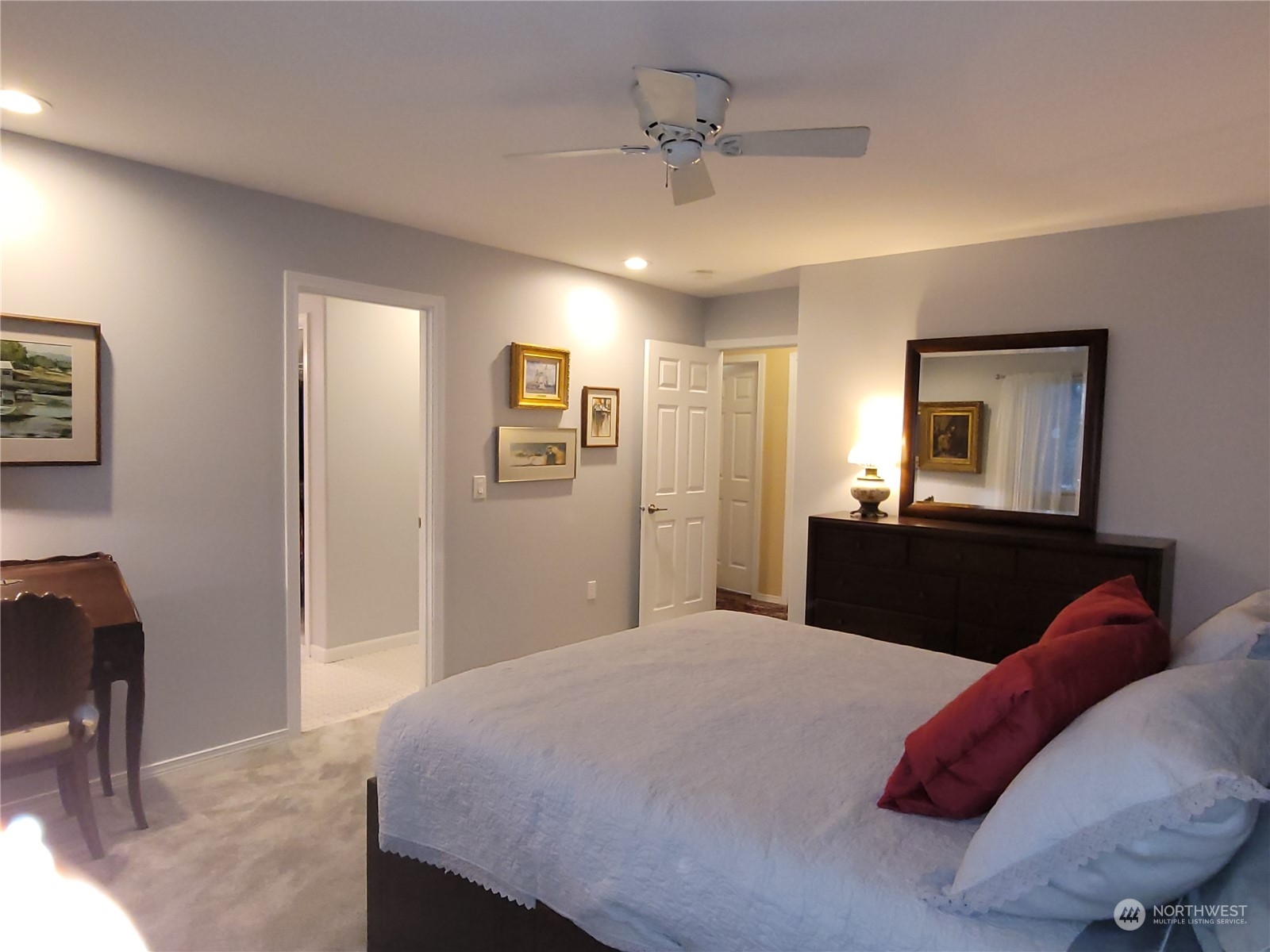 590 East Bush Point Road Freeland, WA 98249 - Photo 14 of 25 a bedroom with a bed and a chandelier