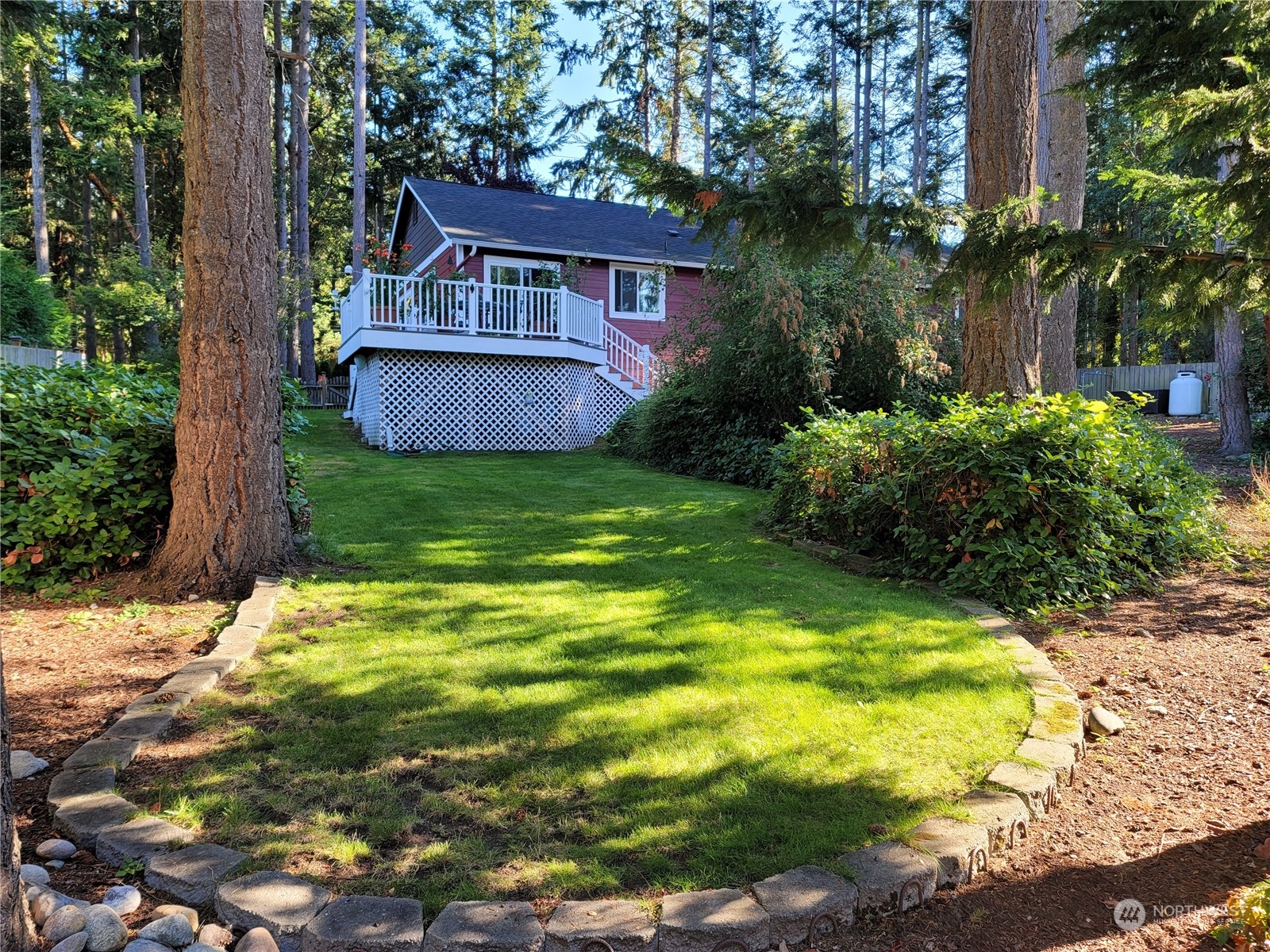 590 East Bush Point Road Freeland, WA 98249 - Photo 24 of 25 a backyard of a house with plants and large tree