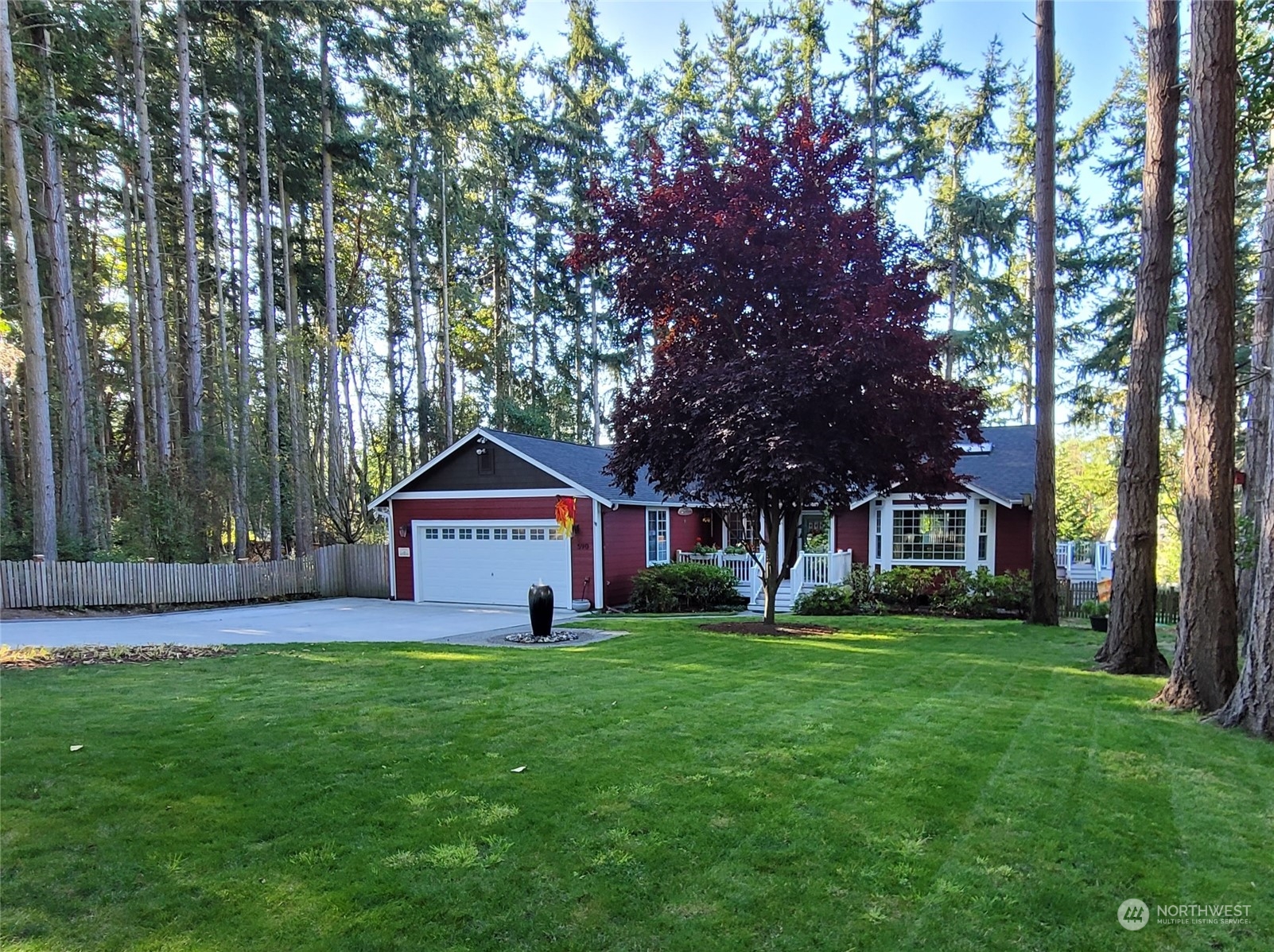 590 East Bush Point Road Freeland, WA 98249 - Photo 25 of 25 a front view of a house with a yard and trees