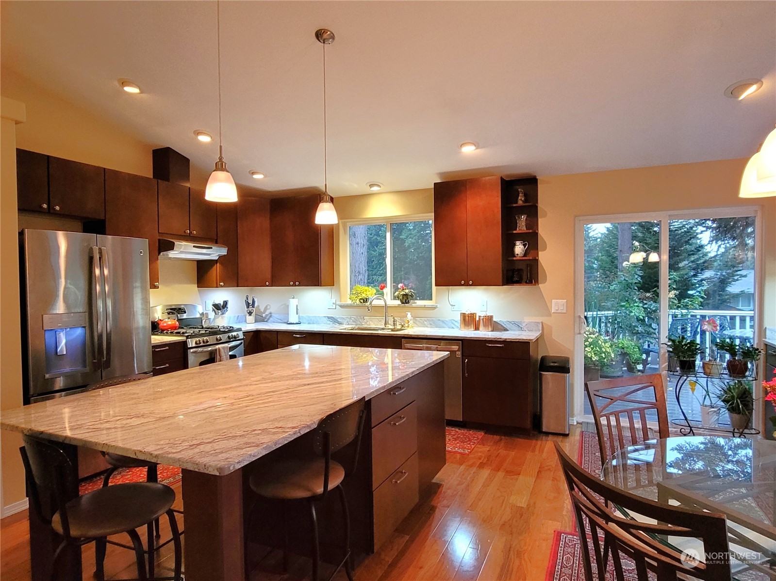 590 East Bush Point Road Freeland, WA 98249 - Photo 7 of 25 a large kitchen with a table and chairs