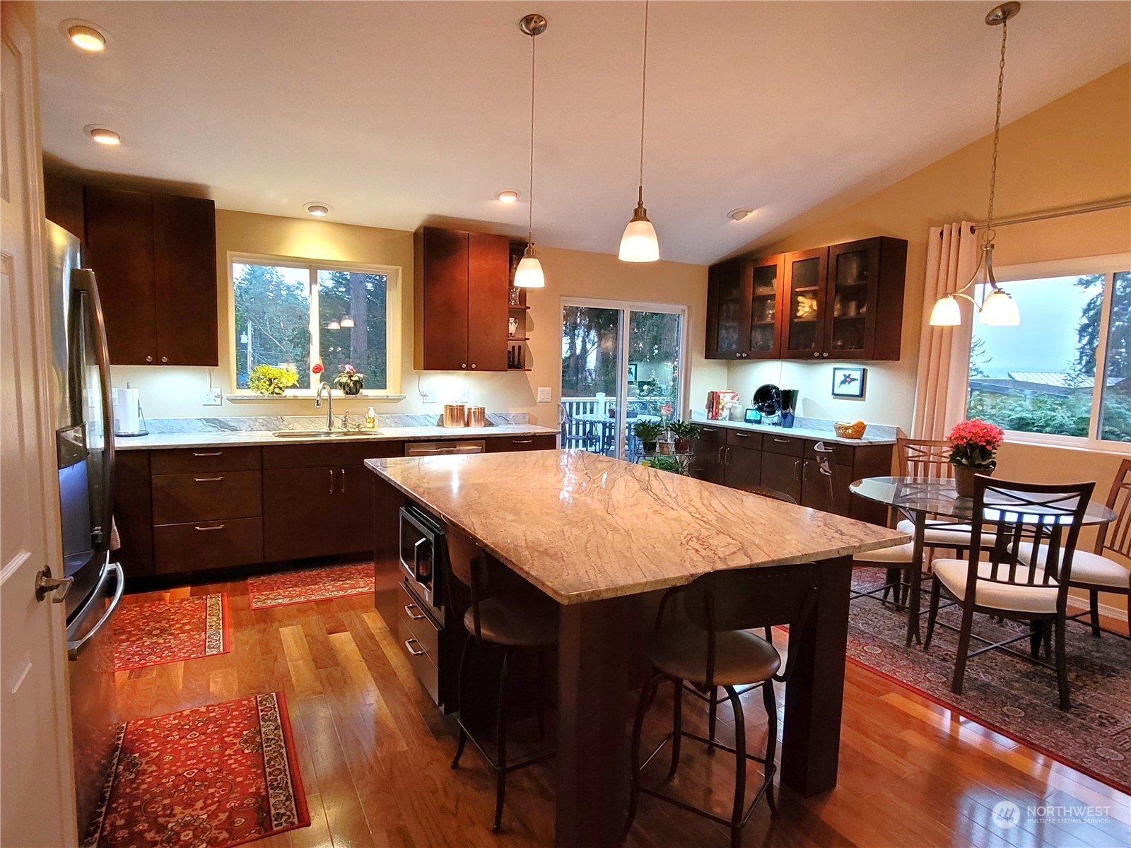 590 East Bush Point Road Freeland, WA 98249 - Photo 9 of 25 a large kitchen with a table and chairs