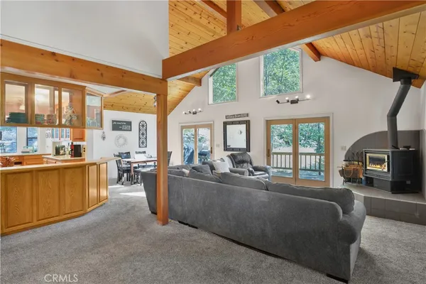 a living room with furniture and large windows