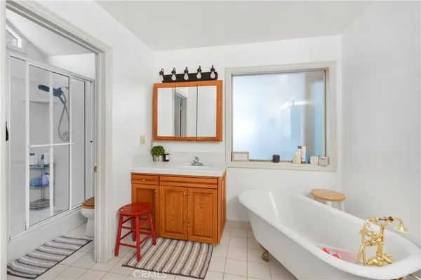 a bathroom with a tub sink and mirror