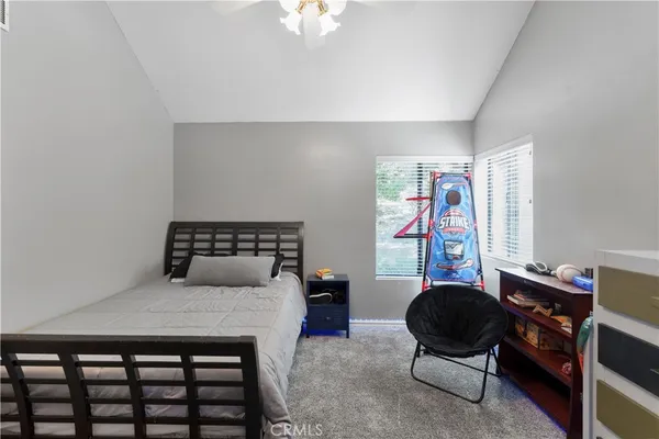 a bedroom with a bed and a desk