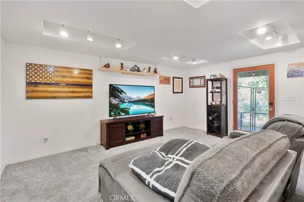 a bedroom with furniture and a flat screen tv