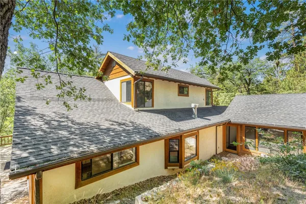 a front view of a house with trees