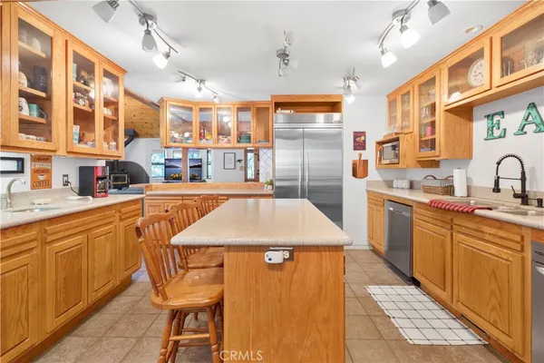 a kitchen with stainless steel appliances kitchen island granite countertop a sink and cabinets