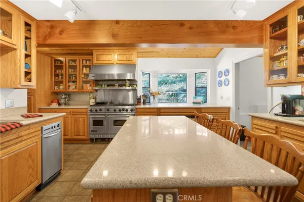 a kitchen with stainless steel appliances granite countertop a stove and a refrigerator