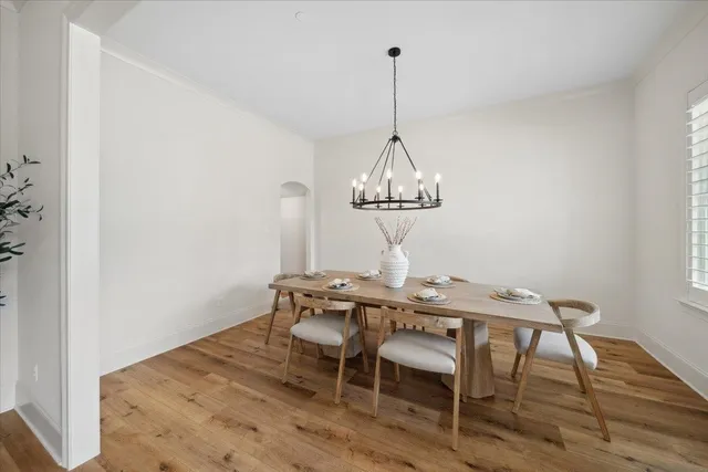 a view of a dining room with furniture wooden floor and chandelier