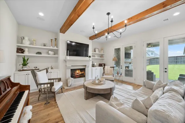 a living room with furniture a fireplace and a flat screen tv