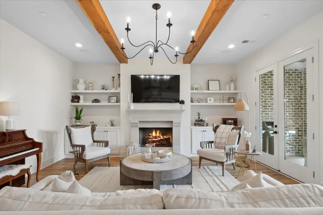 a living room with furniture a fireplace and a flat screen tv