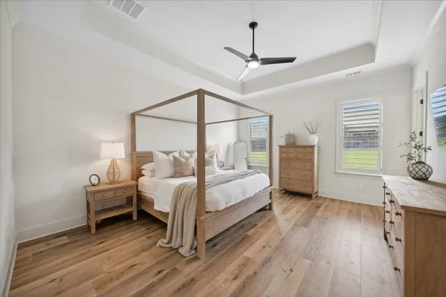 a bedroom with a bed and wooden floor