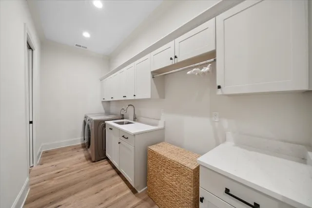 a utility room with sink dryer and washer