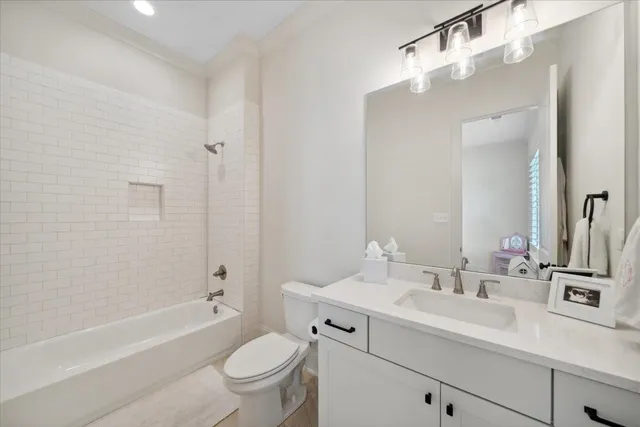 a bathroom with a sink a toilet a tub and shower