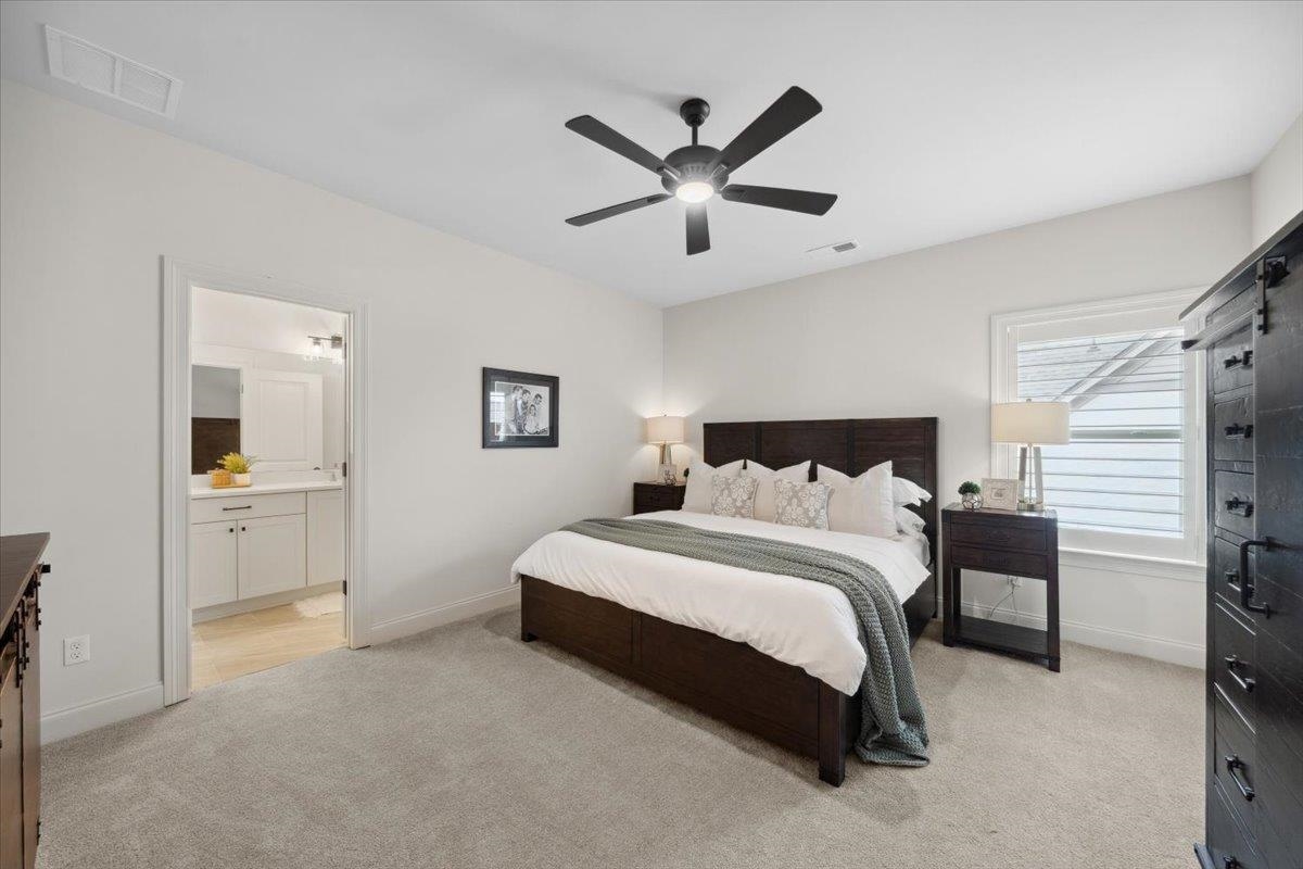 220 Mary Taylor Way Piperton, TN 38017 - Photo 34 of 40 a spacious bedroom with a bed and a view of bathroom