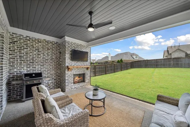 a view of a patio with couches chairs and a fire pit