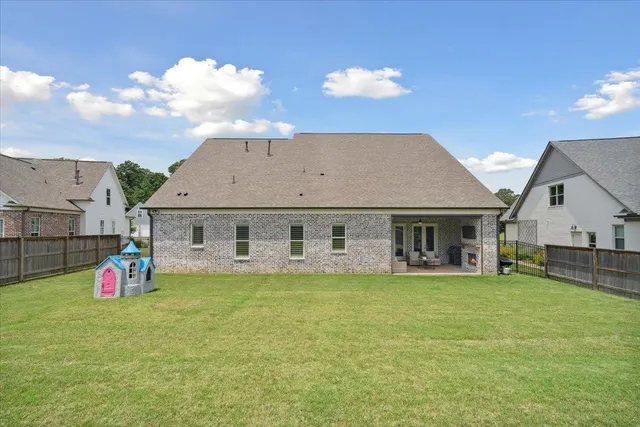 a view of a house with a yard and sitting area