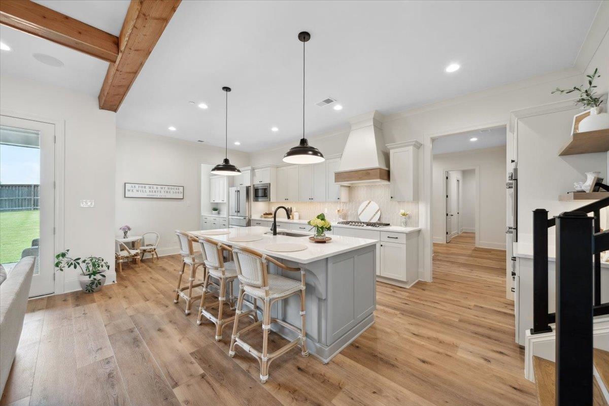 220 Mary Taylor Way Piperton, TN 38017 - Photo 7 of 40 a kitchen with stainless steel appliances a dining table chairs stove and refrigerator