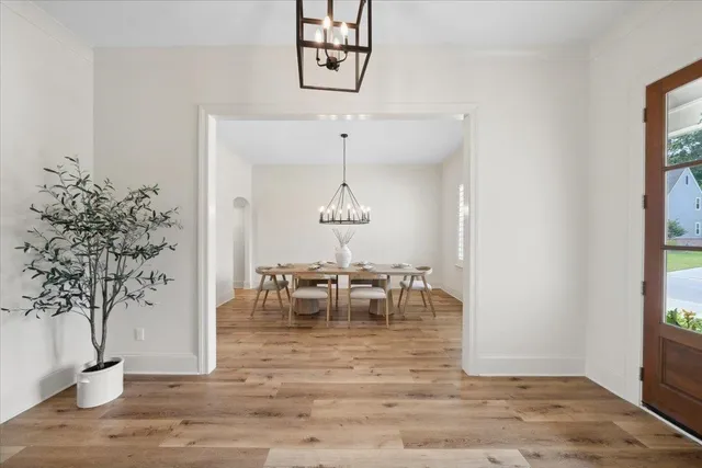 a view of a dining room with furniture window and wooden floor