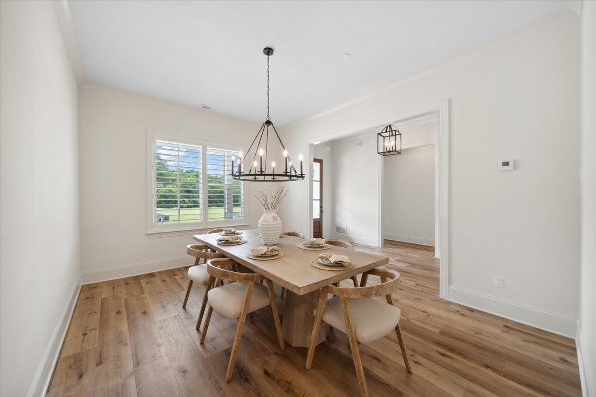 220 Mary Taylor Way Piperton, TN 38017 - Photo 10 of 40 a view of a dining room with furniture window and wooden floor