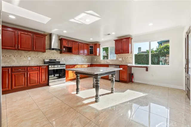 a kitchen with stainless steel appliances kitchen island granite countertop a sink and cabinets