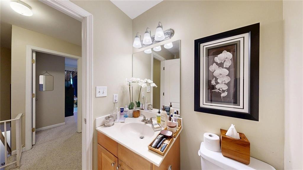 2825 Northeast Expressway, Unit L4 Atlanta, GA 30345 - Photo 20 of 36 a bathroom with a sink a mirror and a painting on the wall