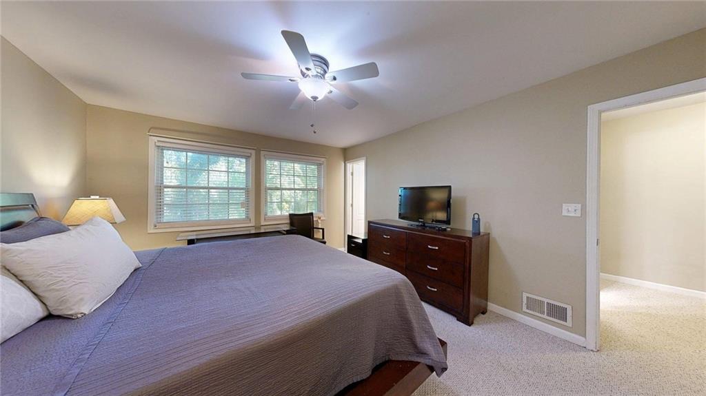 2825 Northeast Expressway, Unit L4 Atlanta, GA 30345 - Photo 22 of 36 a bedroom with a bed and a chandelier