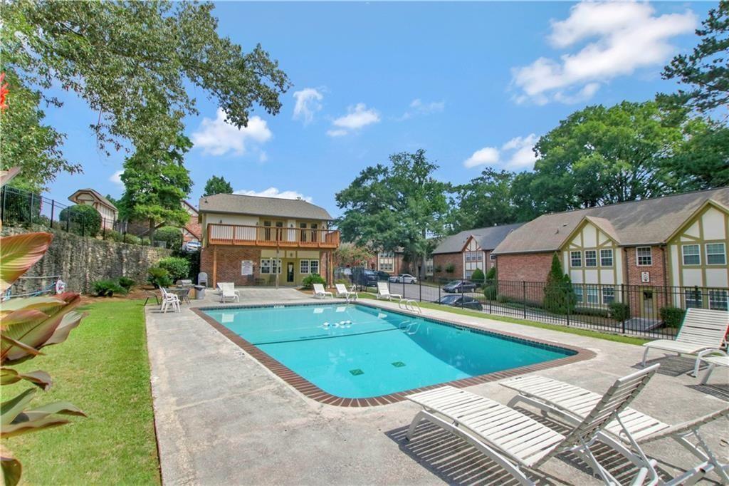 2825 Northeast Expressway, Unit L4 Atlanta, GA 30345 - Photo 31 of 36 a view of a white house with a swimming pool and a yard