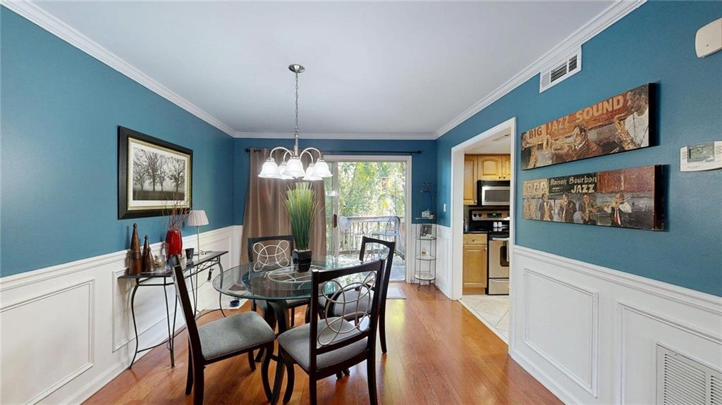 2825 Northeast Expressway, Unit L4 Atlanta, GA 30345 - Photo 7 of 36 a view of a dining room with furniture window and wooden floor