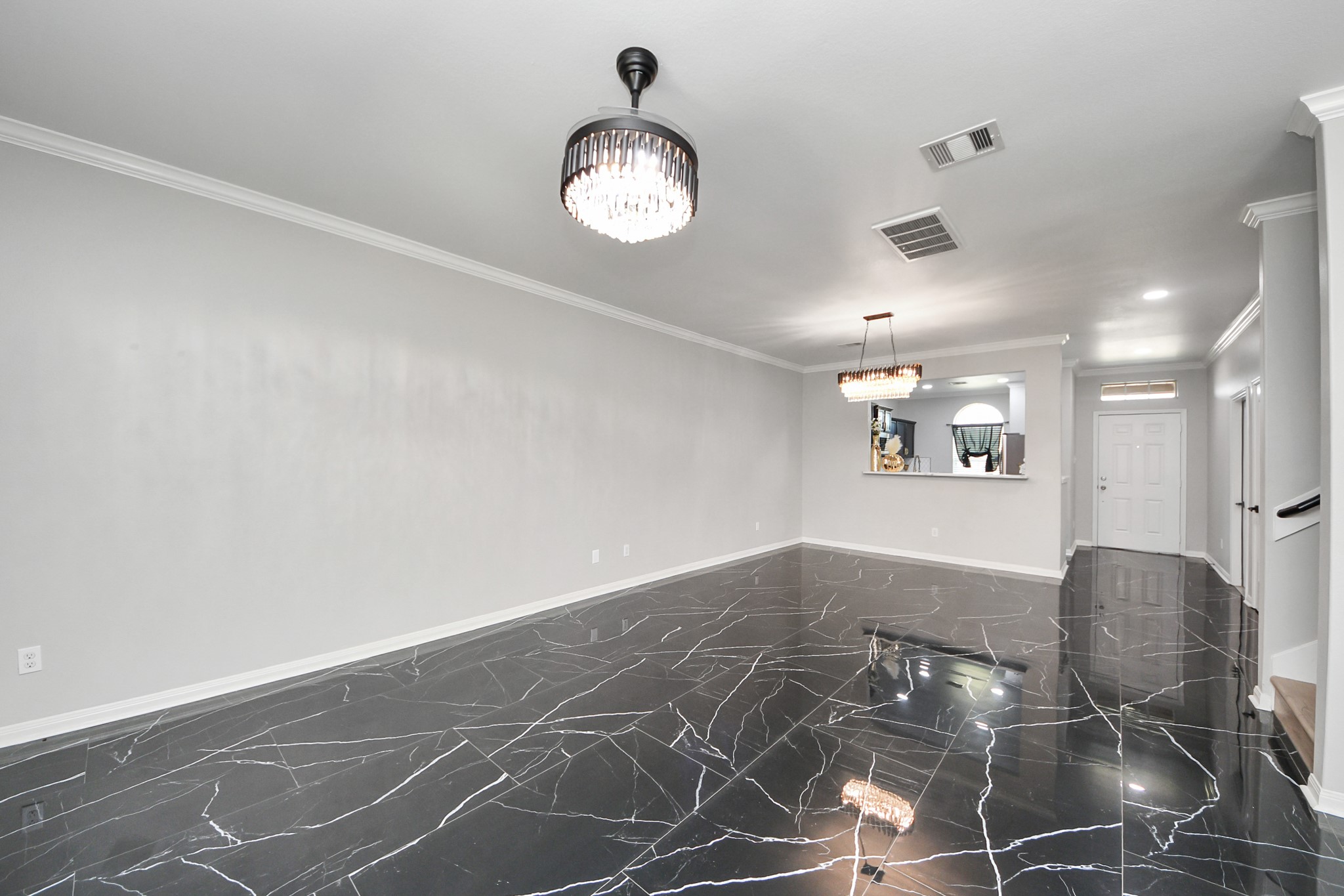 6931 Primrose Road Baytown, TX 77521 - Photo 15 of 50 Open living and dining space with sleek marble floors and elegant lighting.